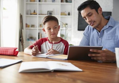 hispanic-pre-teen-boy-sitting-table-working-his-home-school-tutor-using-tablet-computer-144582842